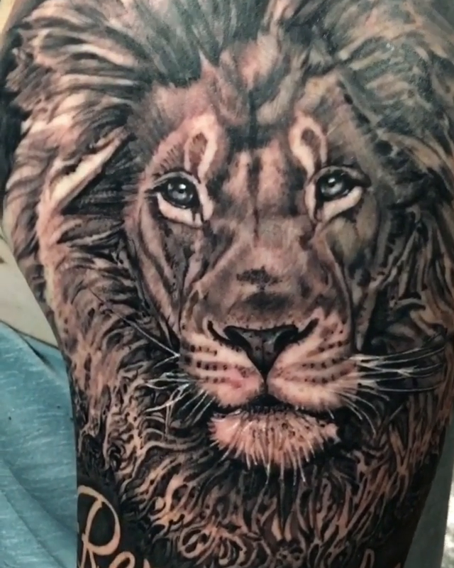 Lion with script realism tattoo by Abel Deida
