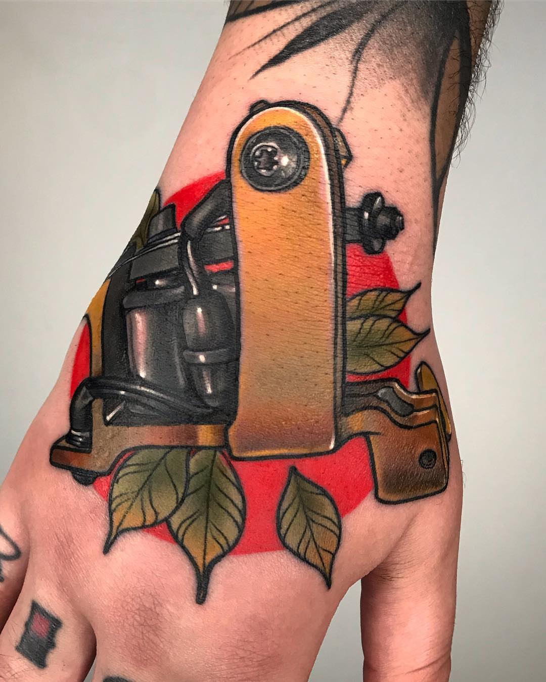 Gun and leaves American traditional tattoo on the forearm by Mario Arcila