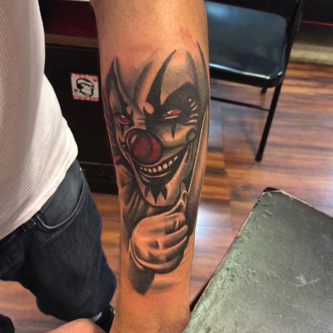 Clown dark realism tattoo on the forearm by Tattoos By Mauze