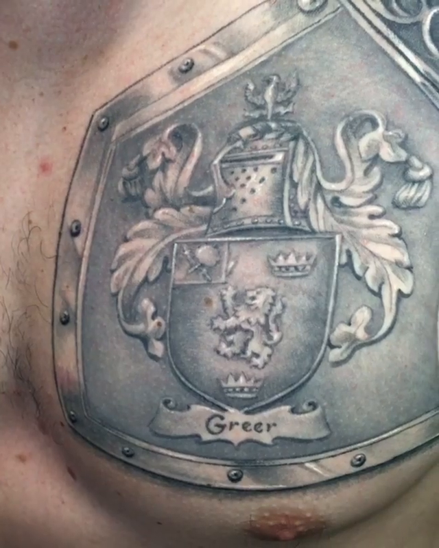 Coat of arms on armor realism tattoo by Abel Deida