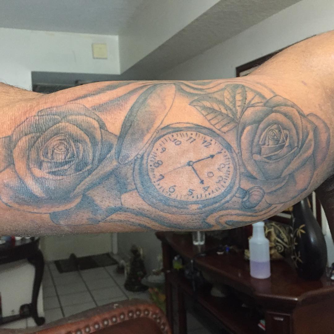 Clock and roses realism tattoo on the forearm by Junior Trevino