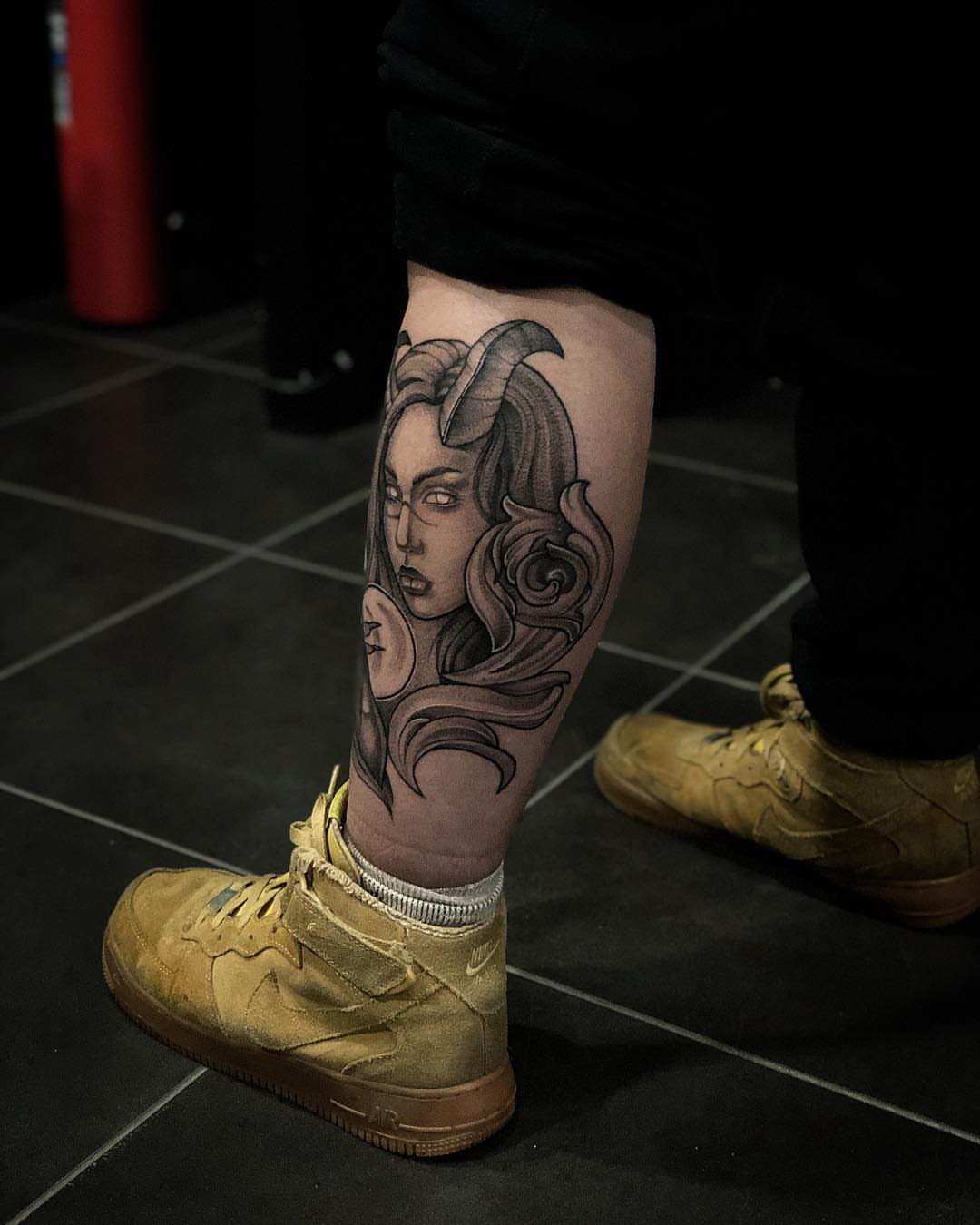 Woman with horns realism tattoo on the calf by Nikita Grinenko, San Francisco