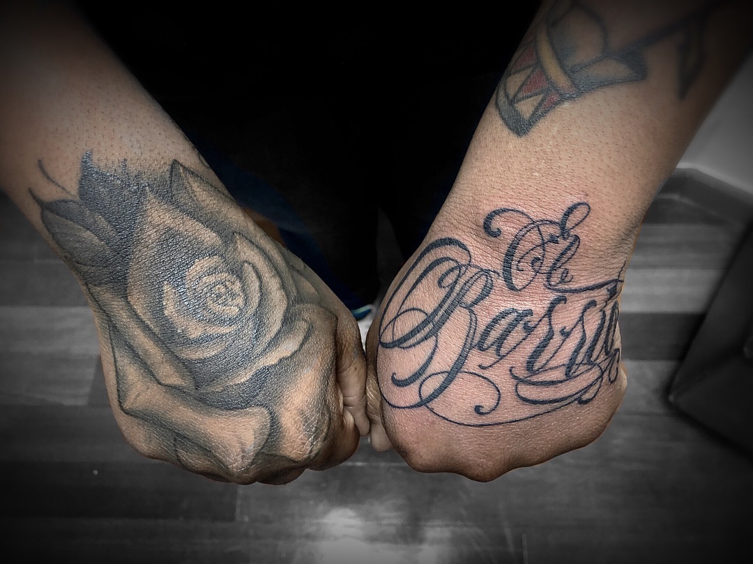 Rose and script lettering script tattoo on the hand by DJ 👨🏾‍🎨
