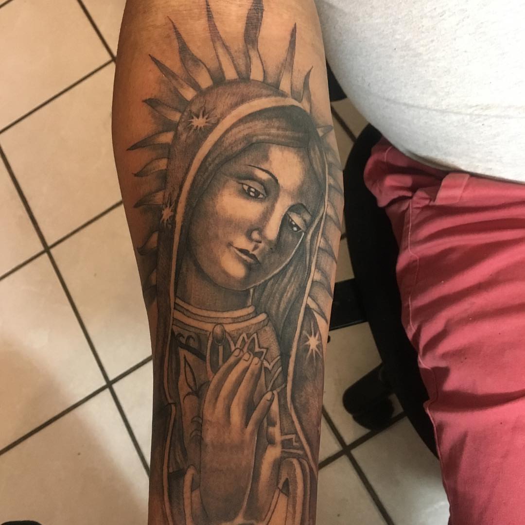 Religious figure realism tattoo on the forearm by Junior Trevino