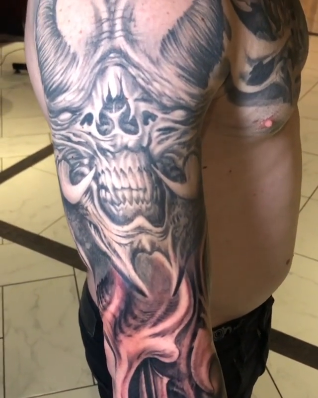Biomechanical skull and face sleeve dark realism tattoo by Oak Adams