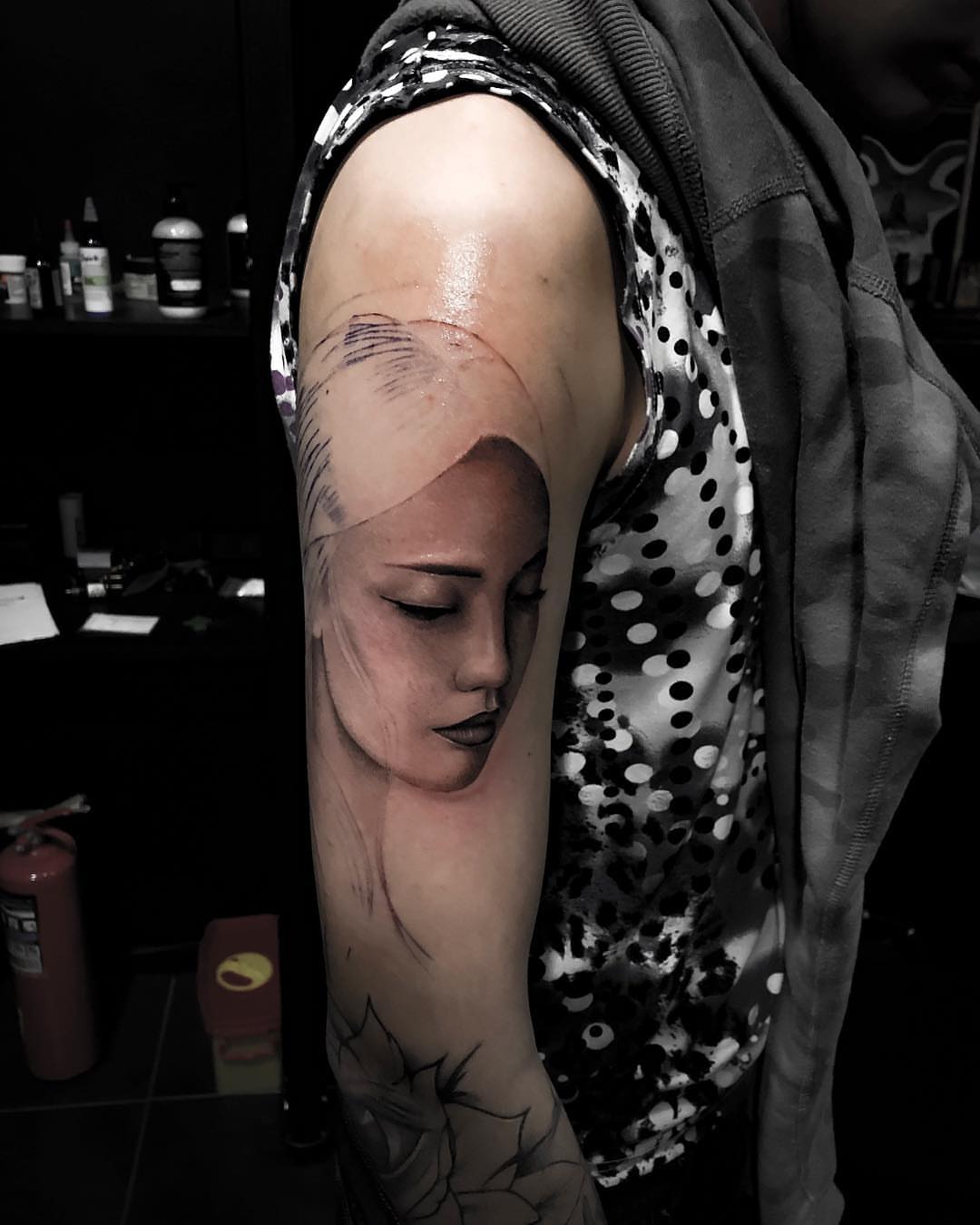 Female face realism tattoo on the forearm by Nikita Grinenko, San Francisco