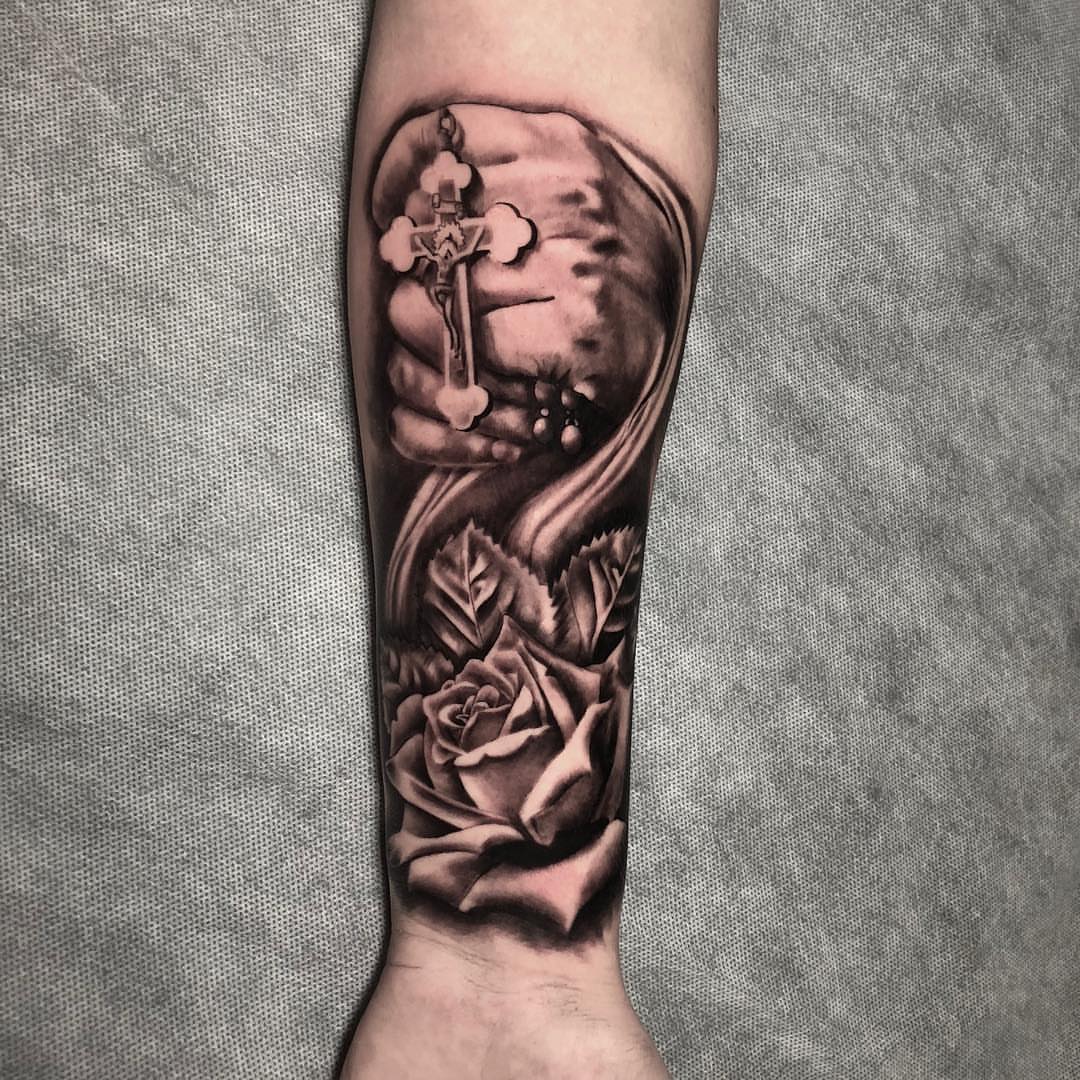 Cross and roses realism tattoo on the forearm by Dalton King Pensacola Tattooer