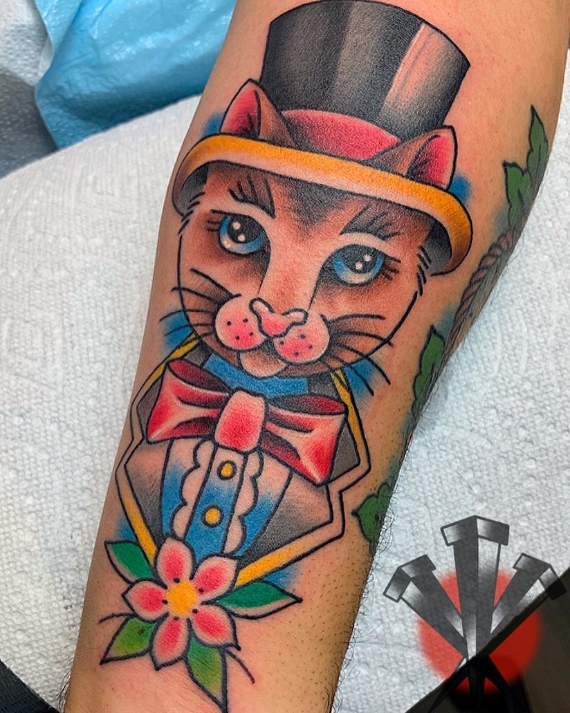 Cat in top hat American traditional tattoo on the forearm by George Weibe