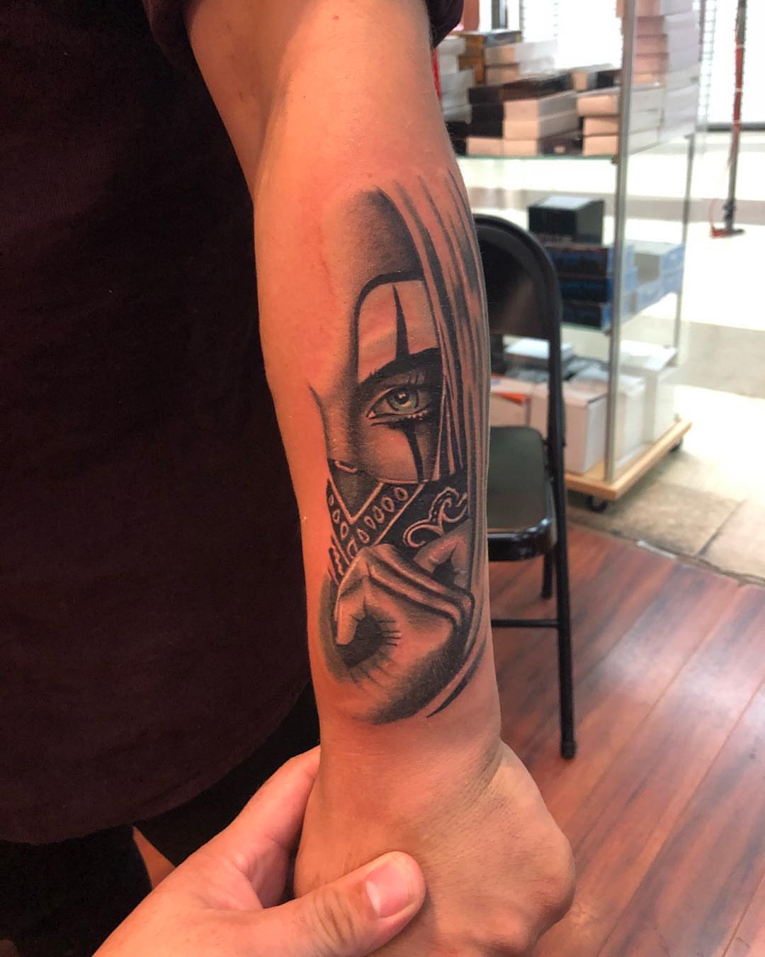 Mask with eye realism tattoo on the forearm by Tattoos By Mauze