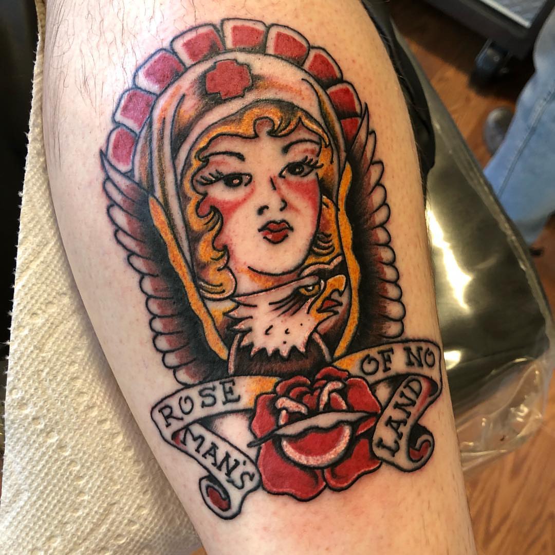 Woman with wings American traditional tattoo on the thigh by Strange Brew Tattoo