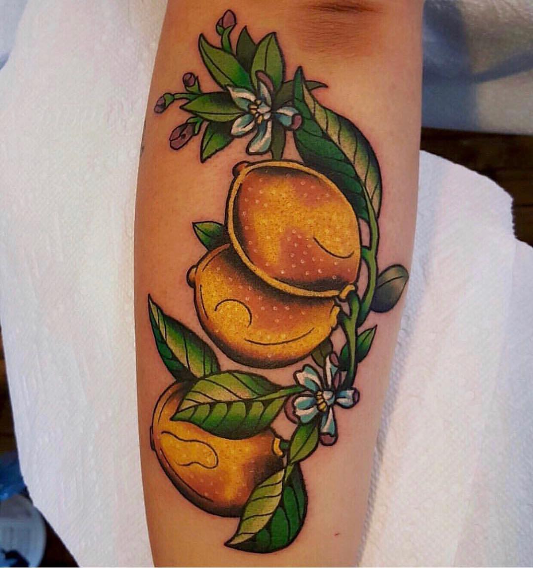 Lemons and flowers American traditional tattoo on the forearm by David Mendieta