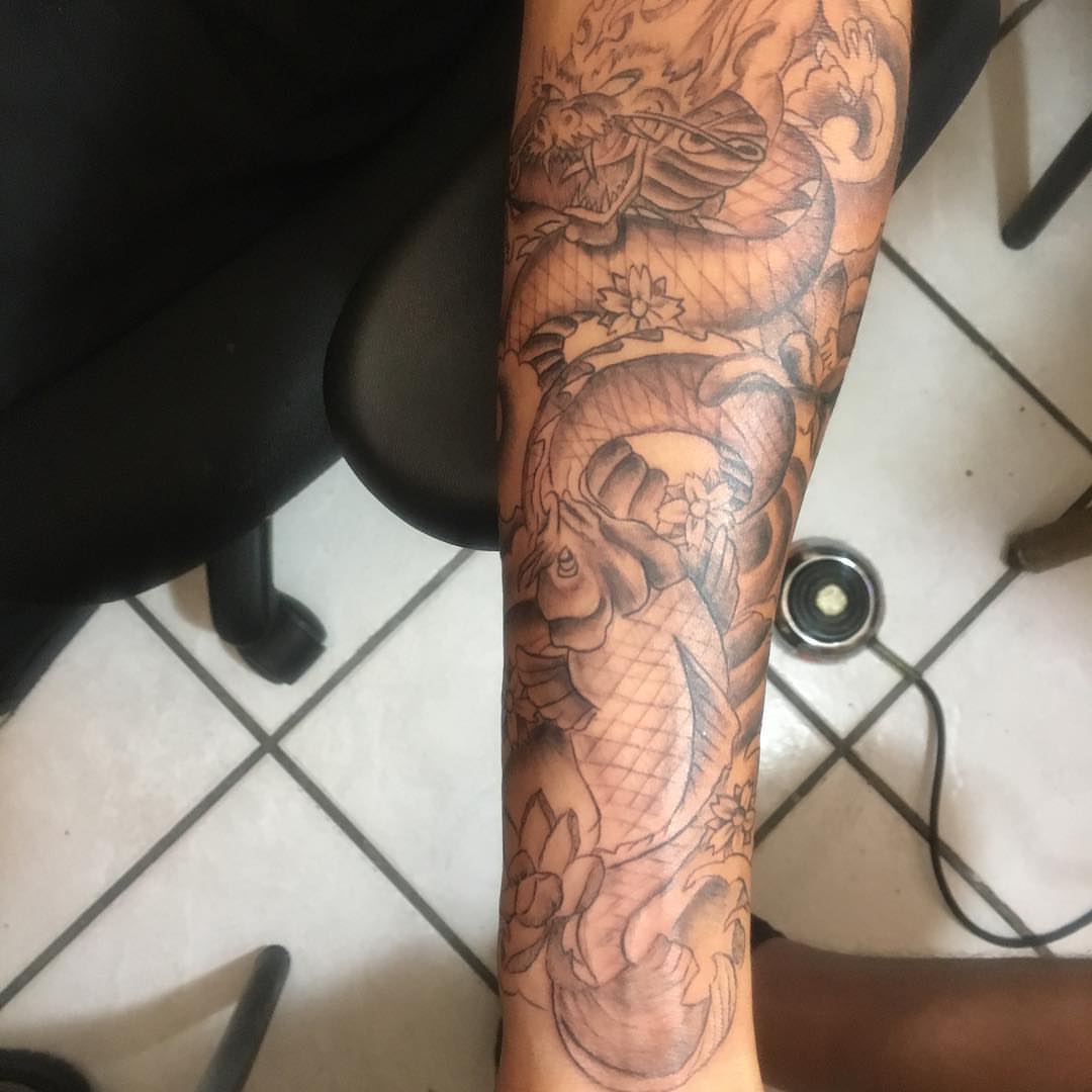 Koi fish and dragon japanese irezumi tattoo on the forearm by Junior Trevino