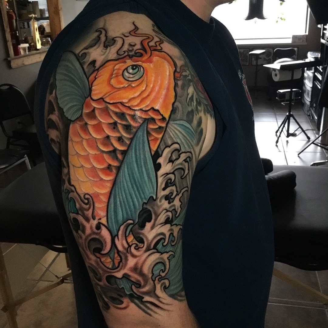 Koi fish japanese irezumi tattoo on the upper arm by Phil Robertson