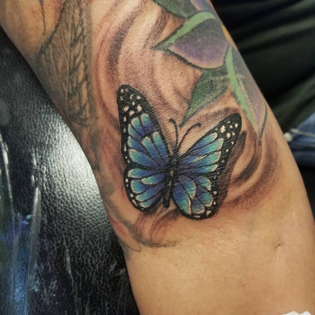 Blue butterfly realism tattoo on the forearm by Anthony Coleman, Midland, Texas