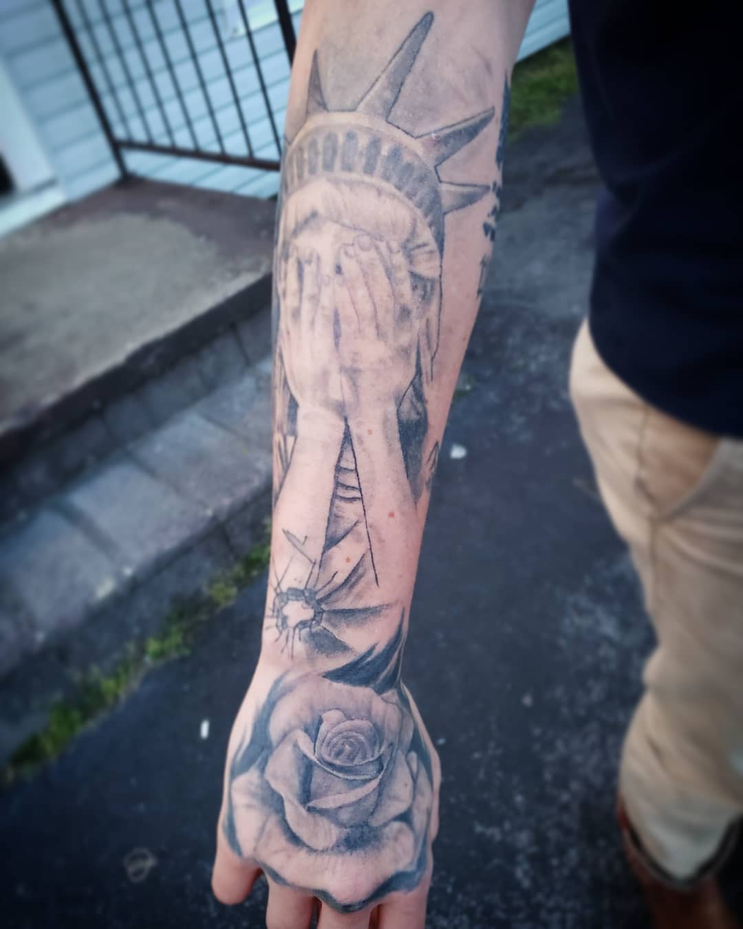 Statue of liberty black and grey tattoo on the forearm by Kayla Linton