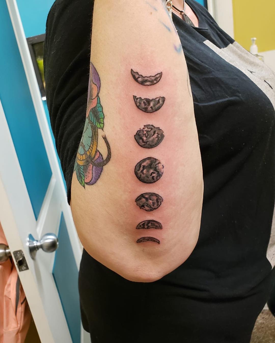 Moon phases black and grey tattoo on the forearm by Sally Darling