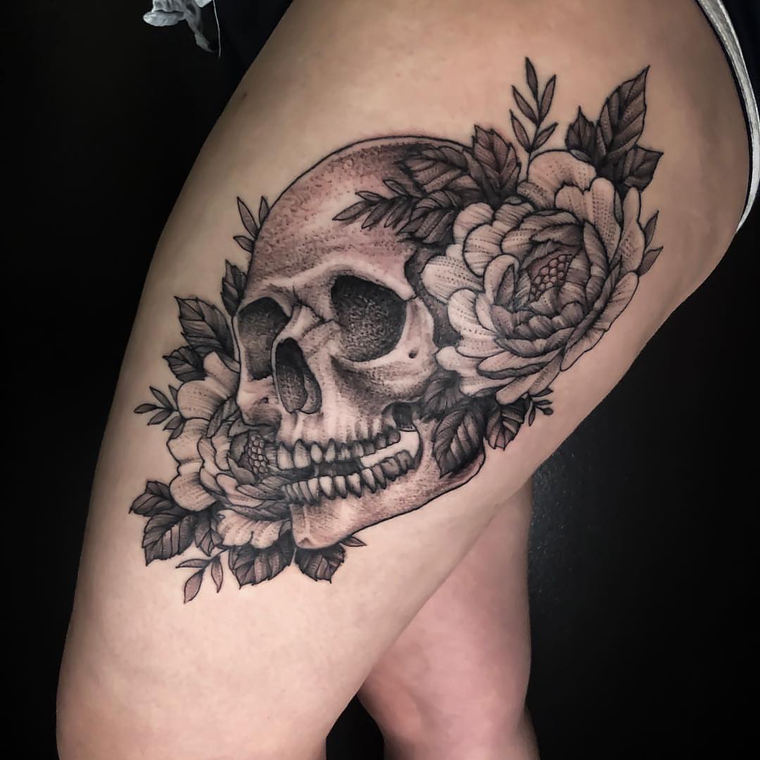 Skull and flowers realism tattoo on the thigh by Michigan Tattoo Artist