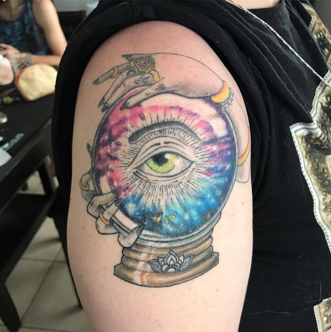 All-seeing eye in a crystal ball geometric tattoo on the shoulder by Chris