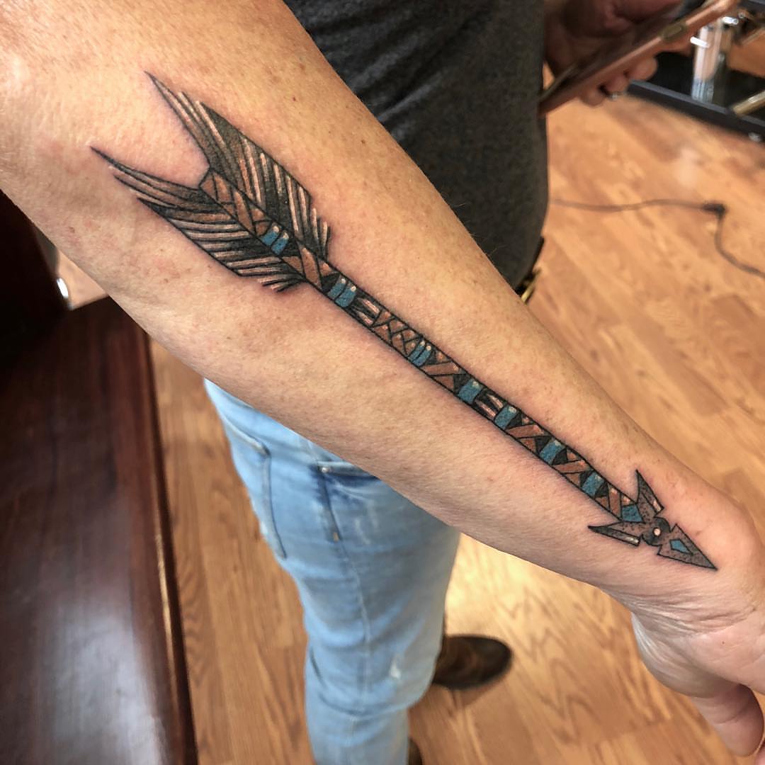 Feather geometric tattoo on the forearm by Strange Brew Tattoo