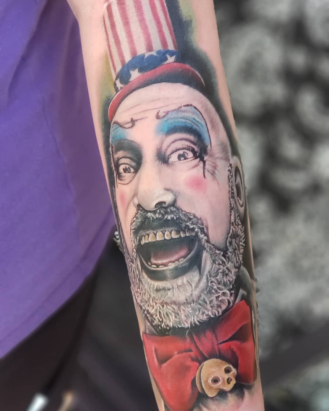 Clown portrait realism tattoo on the forearm by Jon Goad