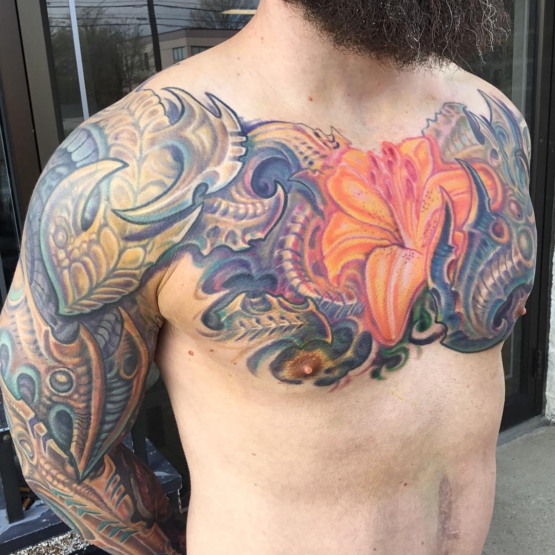 Floral and abstract new school tattoo on the chest by Phil Robertson