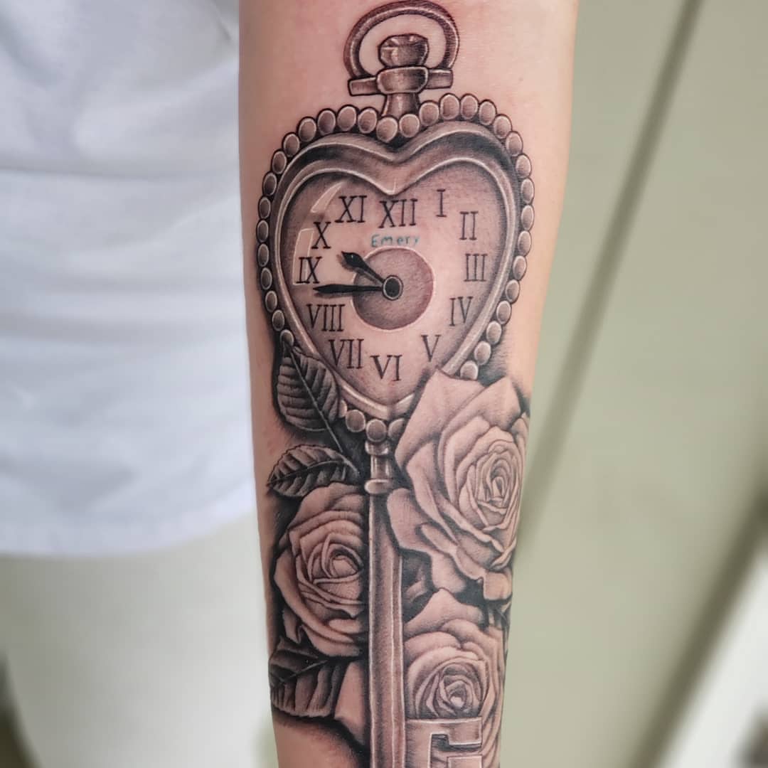 Heart-shaped pocket watch realism tattoo on the forearm by Jon Goad