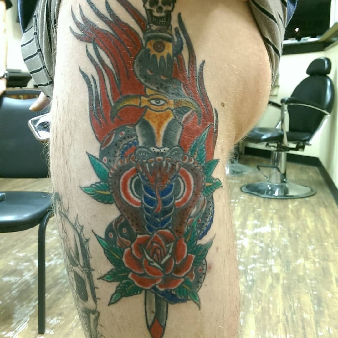 Snake and peony American traditional tattoo on the thigh by Rue McLean