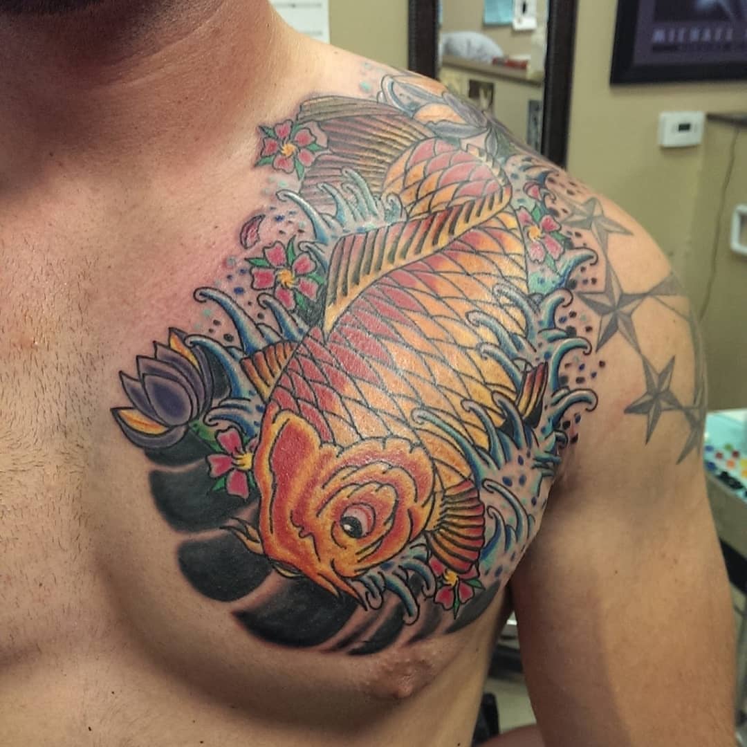 Koi fish American traditional tattoo on the chest by Rue McLean