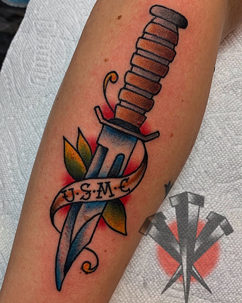 Knife and ribbon American traditional tattoo on the forearm by George Weibe