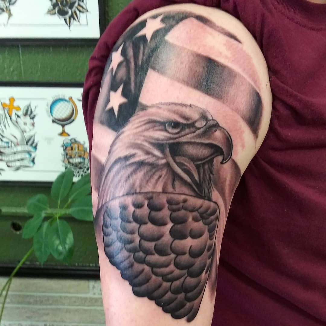 Eagle and american flag realism tattoo on the upper arm by Dorrough Tattooer