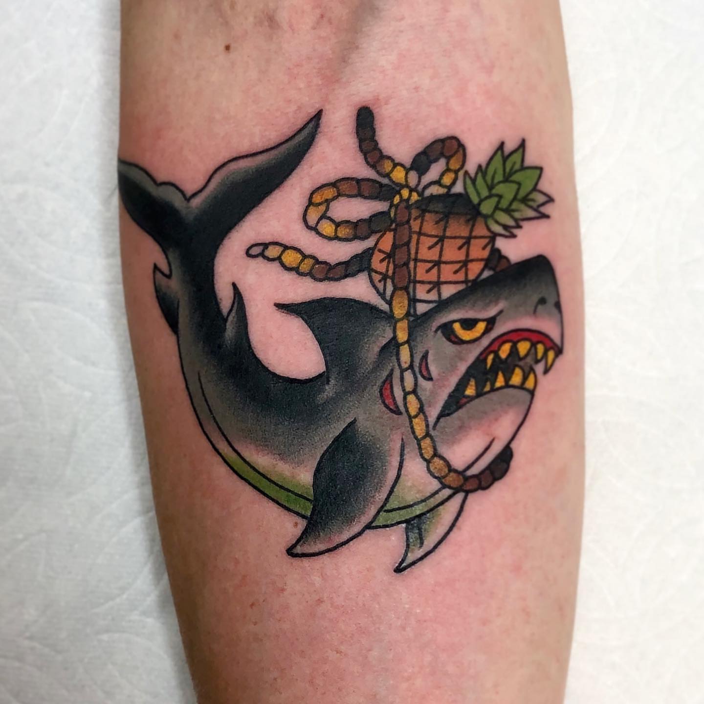 Shark and pineapple American traditional tattoo on the forearm by David Mendieta
