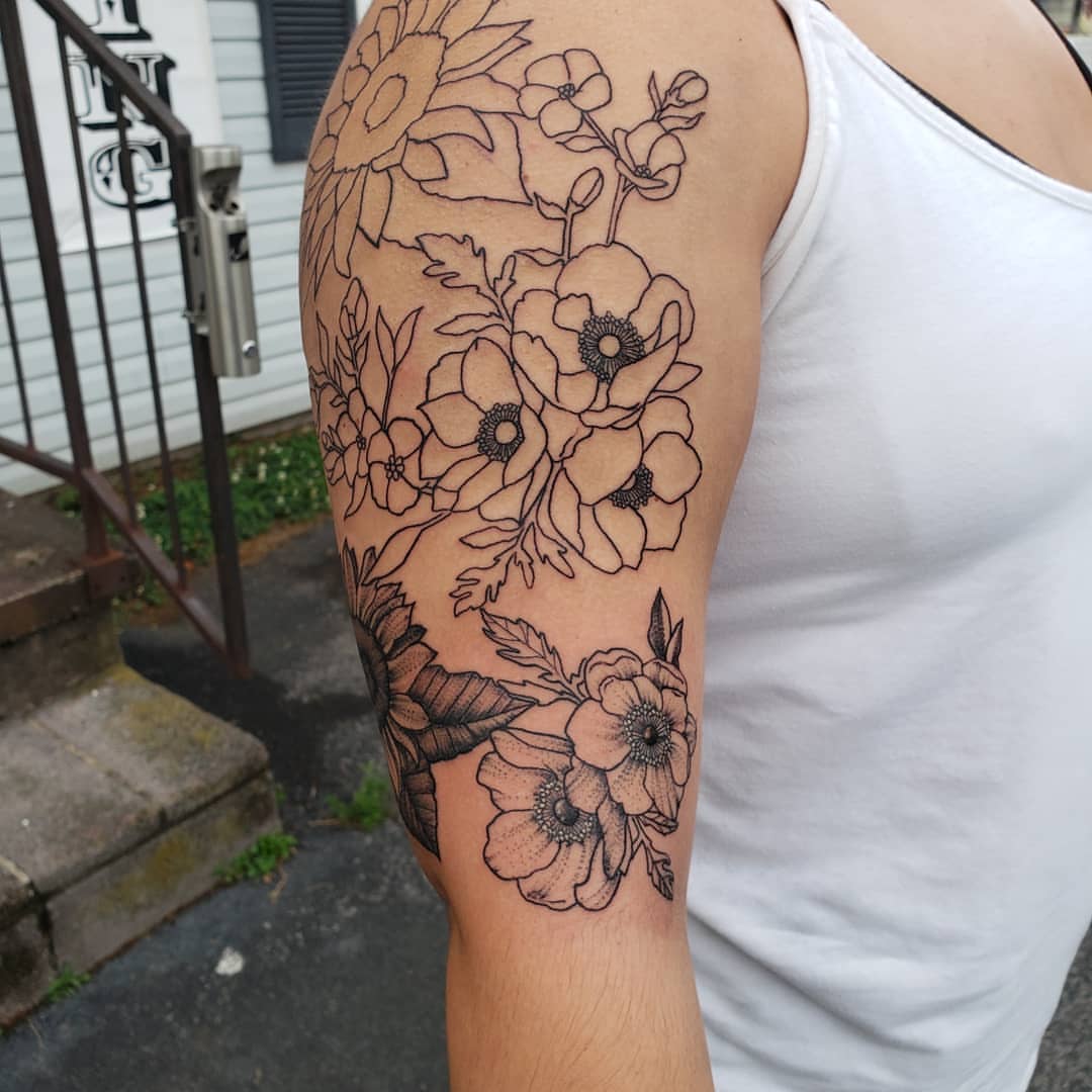 Floral bouquet black and grey tattoo on the forearm by Kayla Linton