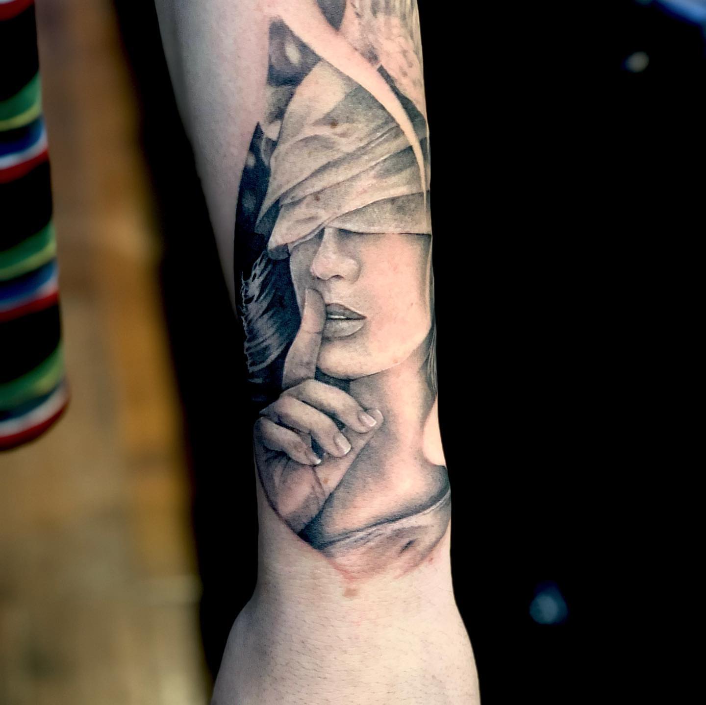 Woman with blindfold realism tattoo on the forearm by Saint Jimmy