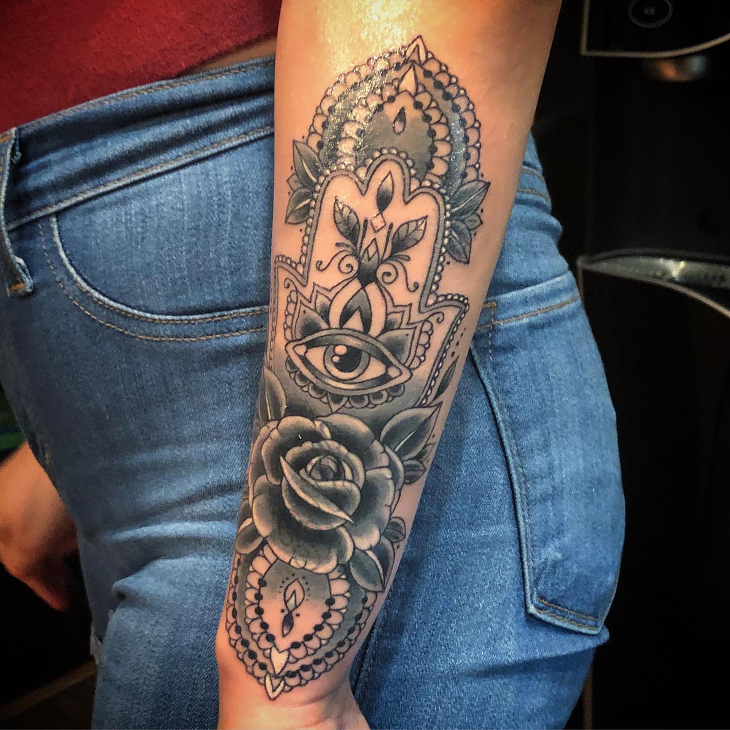 Hamsa hand with eye and roses American traditional tattoo on the forearm by alexandra