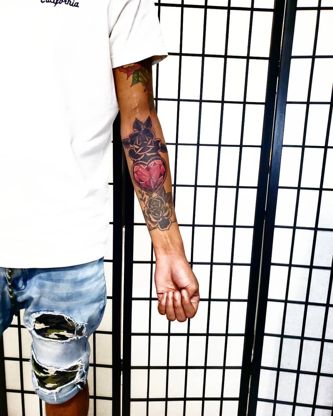 Heart and roses American traditional tattoo on the forearm by Eddy