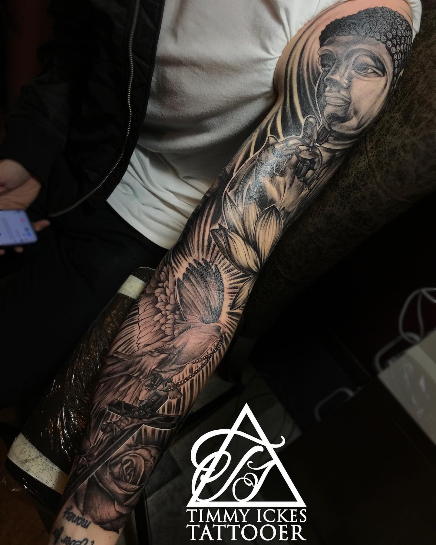 Hip hop artist with dove realism tattoo on the forearm by Timmy Ickes