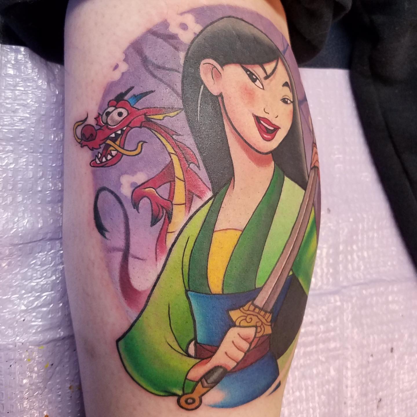 Mulan and Mushu realism tattoo on the forearm by Ariel Robinson