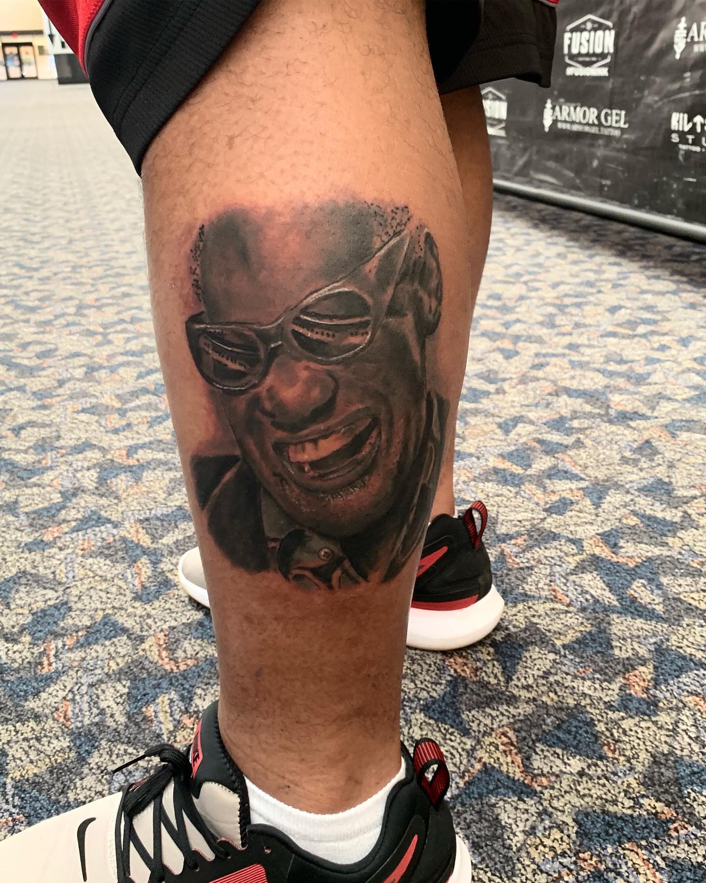 Portrait realism tattoo on the thigh by Sly Davis