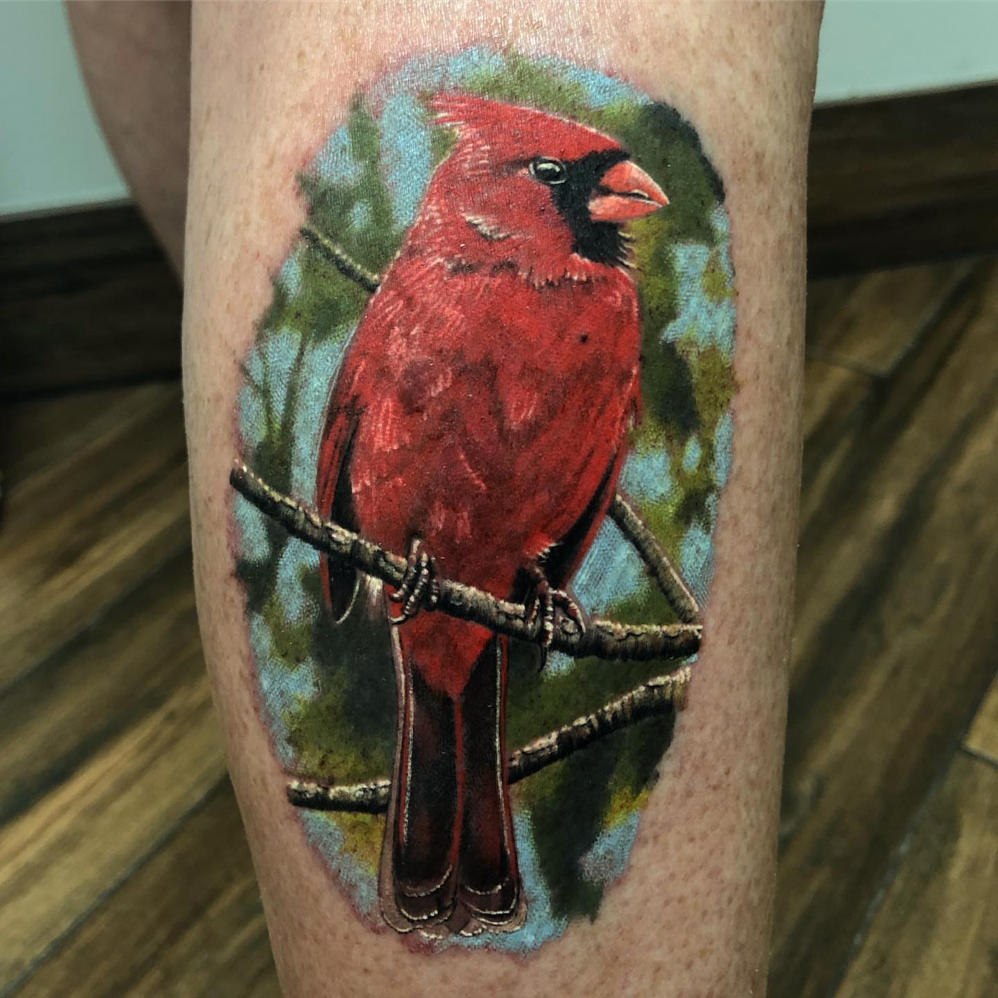 Cardinal bird realism tattoo on the thigh by Jared Ammons