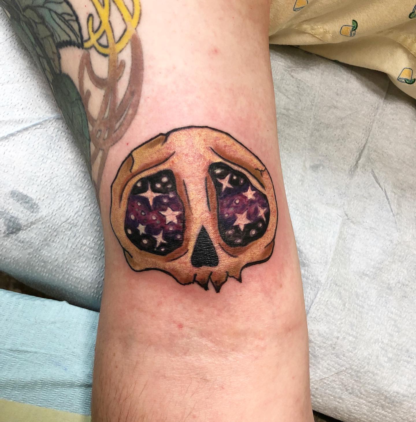 Galactic skull dotwork tattoo on the forearm by Sally Darling