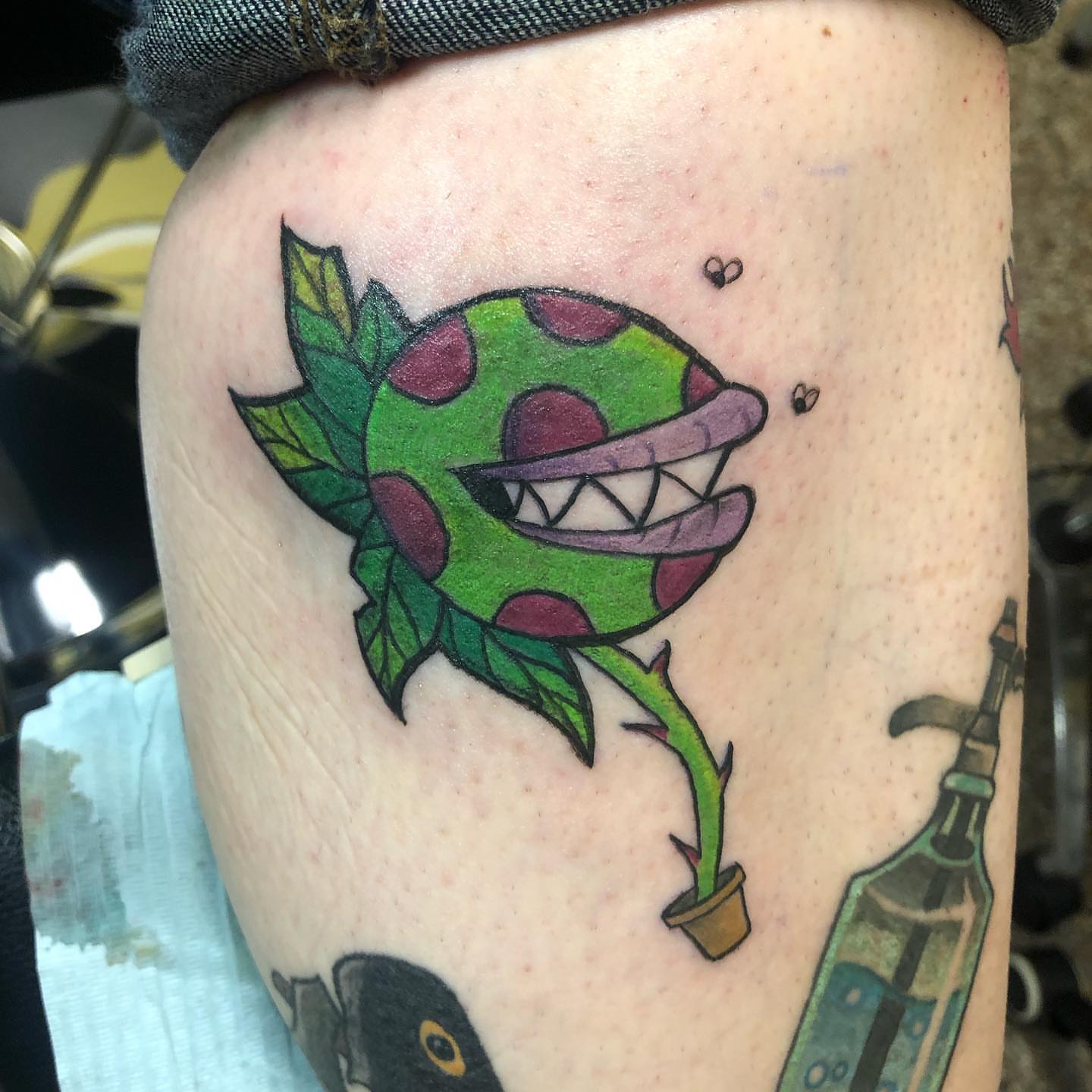 Plant monster trash polka tattoo on the thigh by Sally Darling