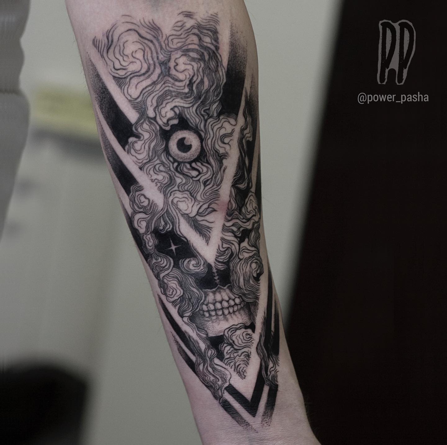 Skull and clouds geometric tattoo on the forearm by Tattoo San Diego