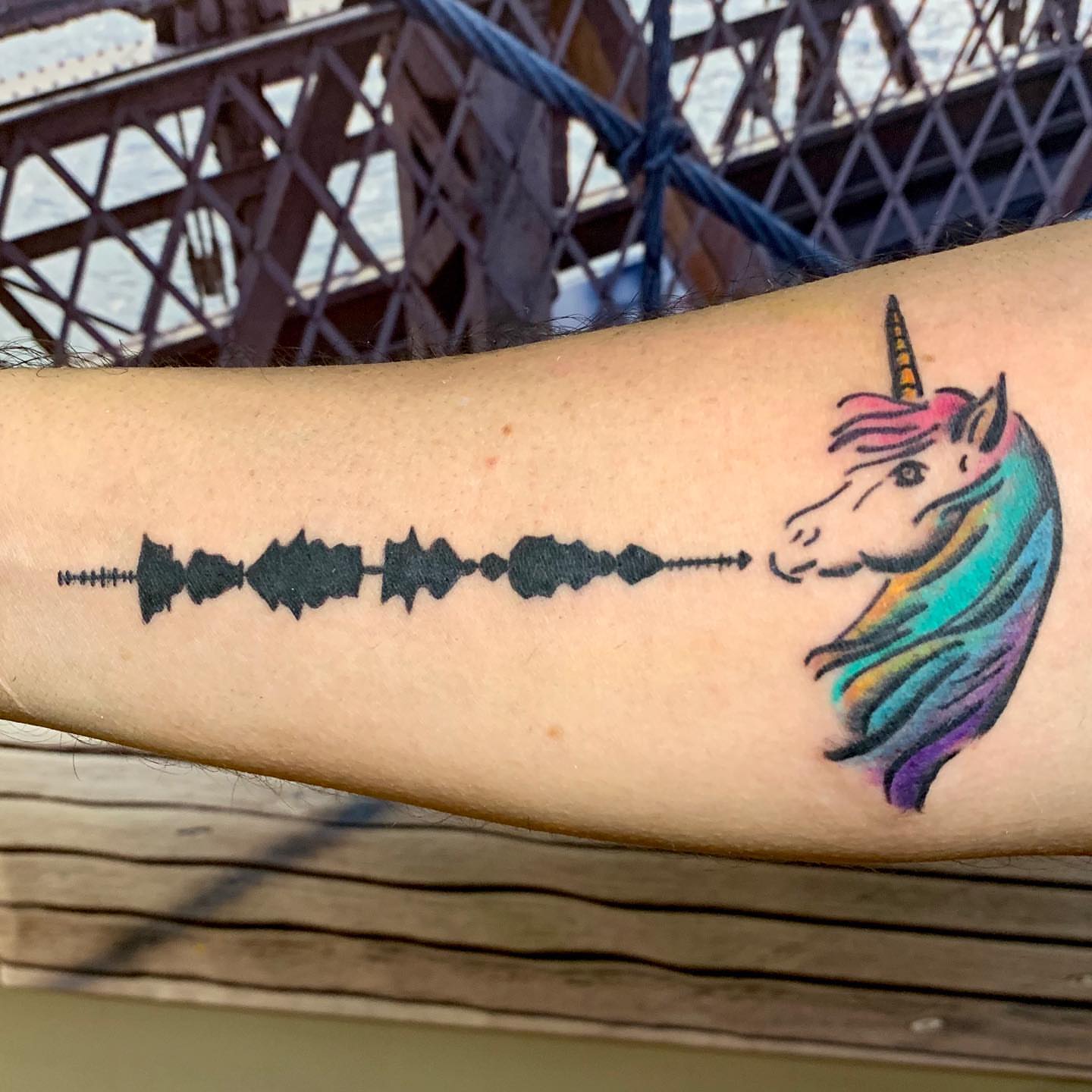 Unicorn and sound wave new school tattoo on the forearm by Rhonda Faber Green