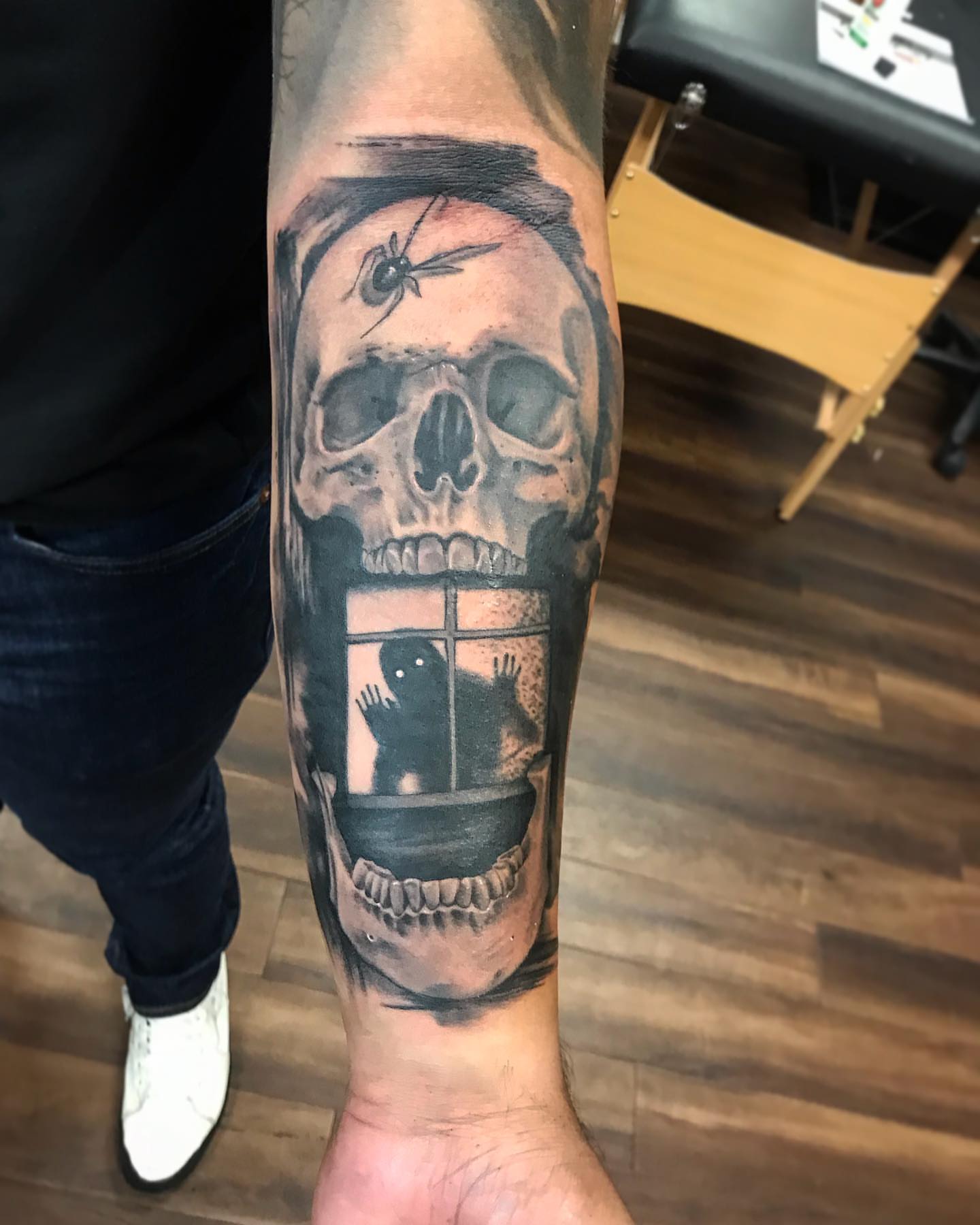Skull with window realism tattoo on the forearm by Junior Nunez