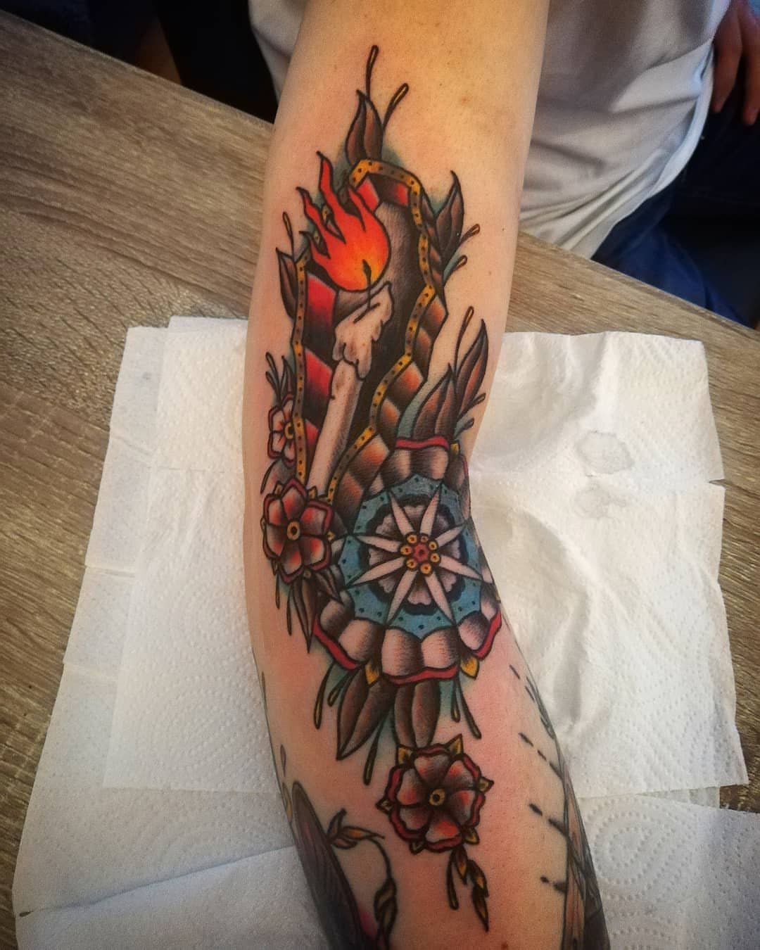 Flame and arrow American traditional tattoo on the forearm by AntiheroTattoo