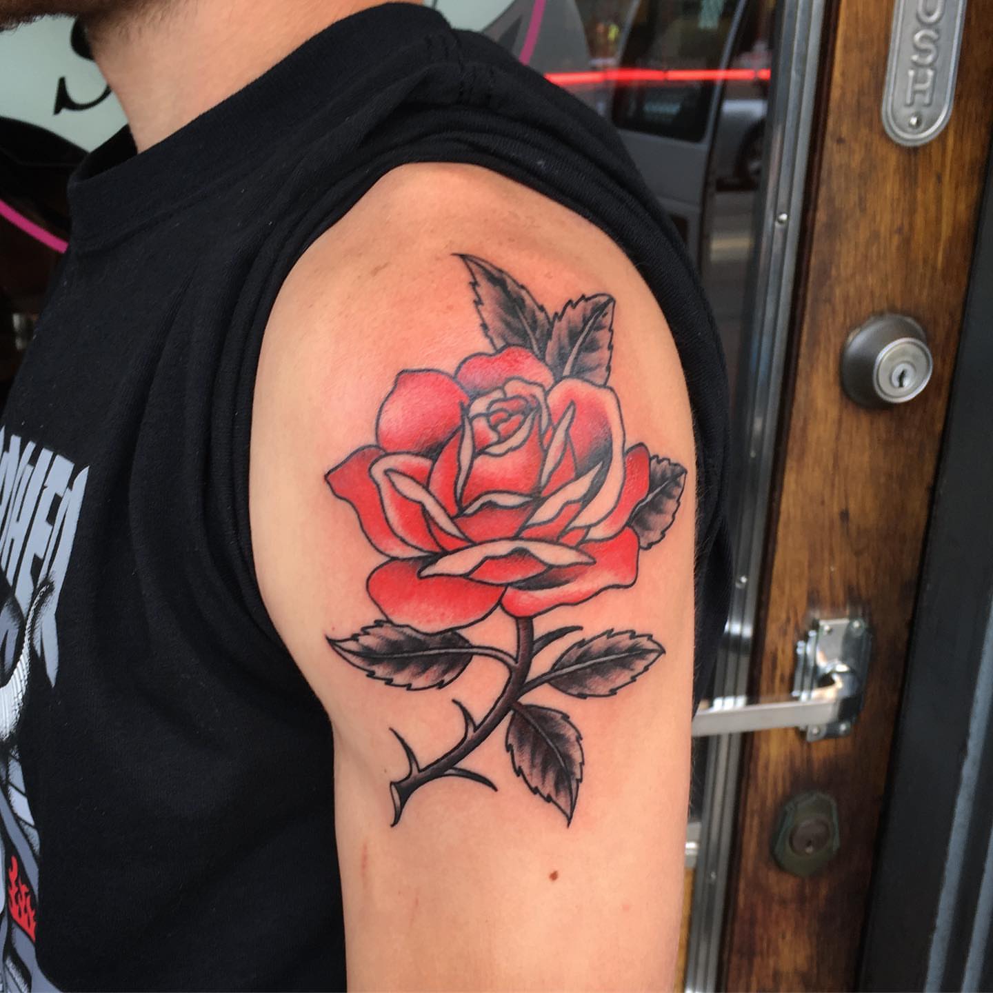 Red rose American traditional tattoo on the shoulder by Paul Trimble