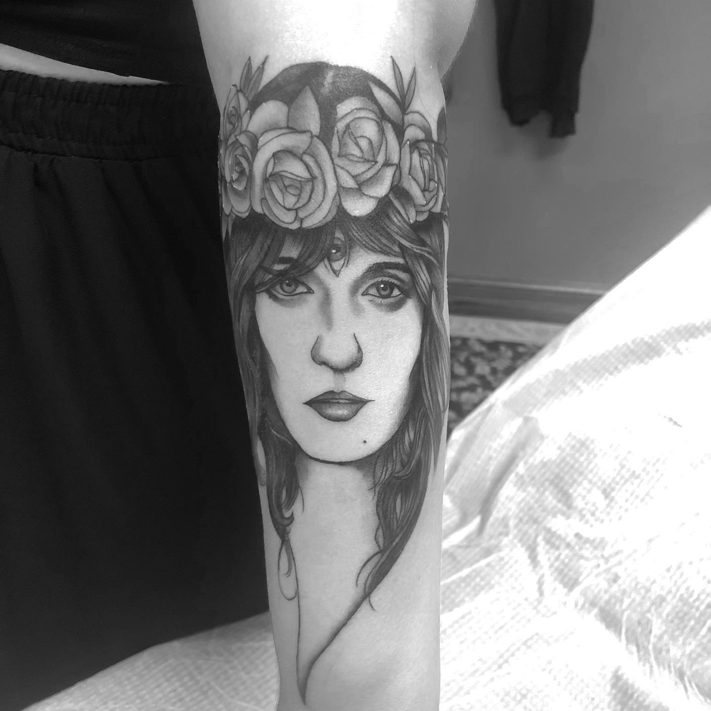 Woman with floral crown realism tattoo on the forearm by Sam Fortney, Columbus, Ohio