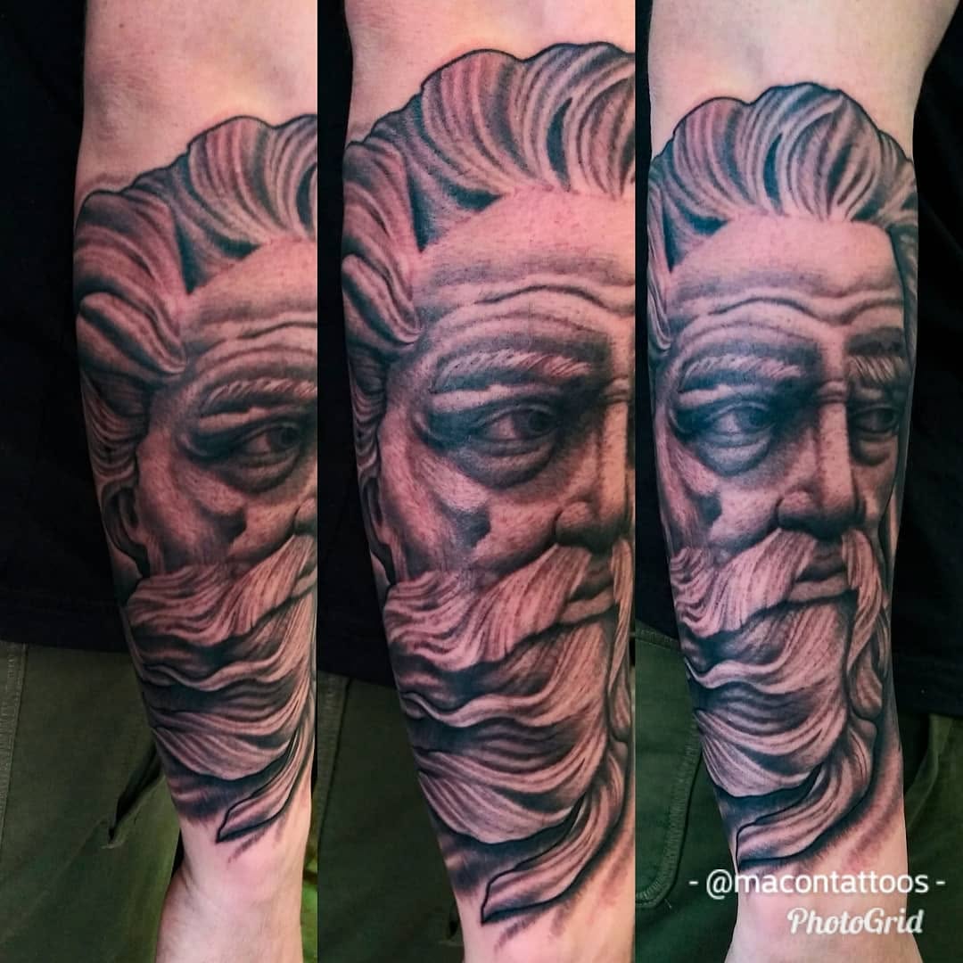Bust of a bearded man surrealism tattoo on the forearm by Dorrough Tattooer