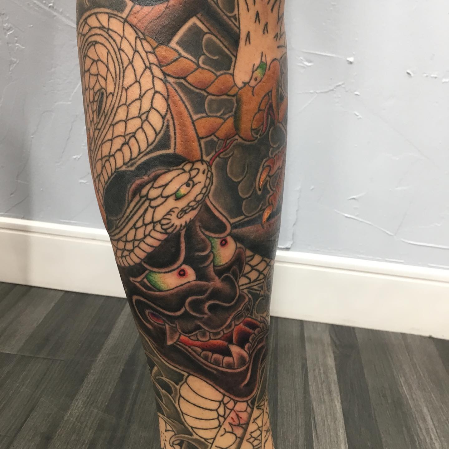 Snake and mask japanese irezumi tattoo on the forearm by Ei Horimiya Omiya