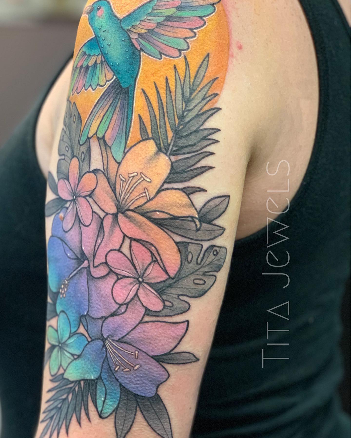 Hummingbird and flowers watercolor tattoo on the forearm by Tita Jewels- Tattoo Artist, Austin, Texas